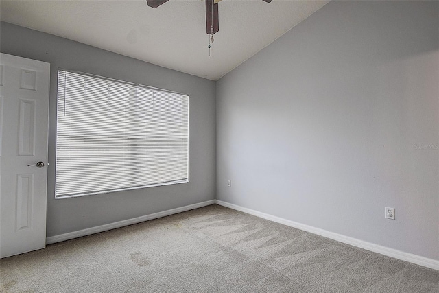 carpeted empty room with plenty of natural light, ceiling fan, and lofted ceiling