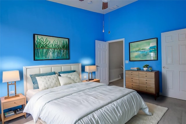 bedroom featuring carpet and a towering ceiling