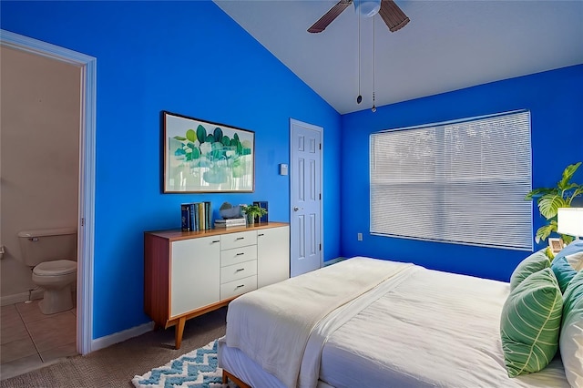 tiled bedroom with ensuite bath, ceiling fan, and lofted ceiling