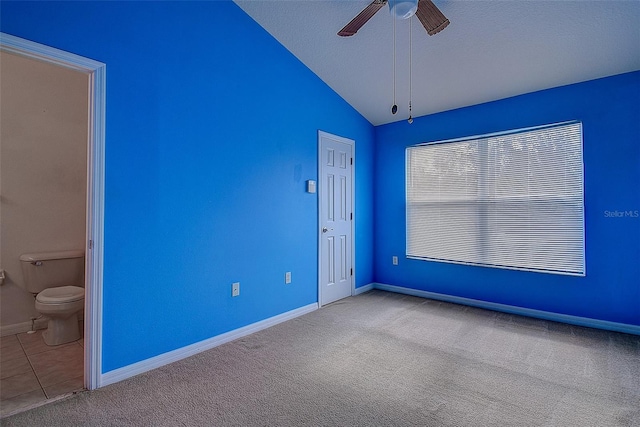 unfurnished room featuring a textured ceiling, ceiling fan, light colored carpet, and lofted ceiling