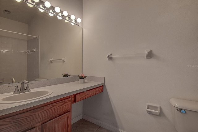 bathroom featuring tile patterned floors, a shower, vanity, and toilet