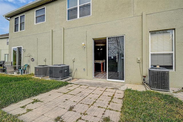 rear view of property featuring a patio area and central air condition unit