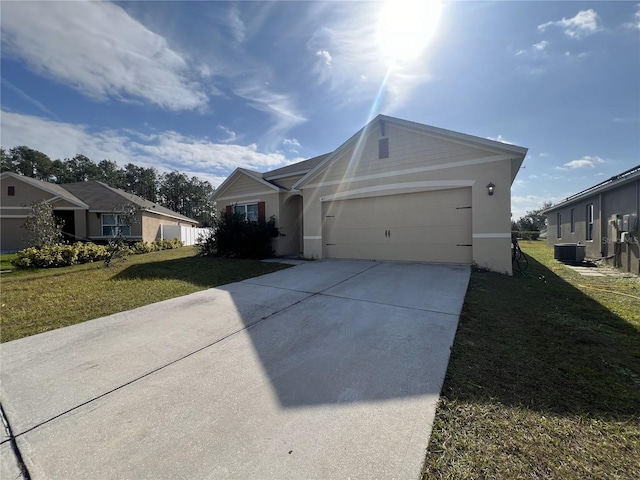 ranch-style home with central AC unit, a garage, and a front lawn