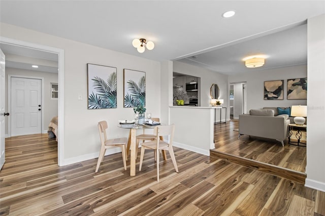 dining space featuring wood-type flooring