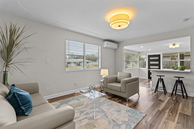 living room with a wealth of natural light, dark hardwood / wood-style floors, and a wall mounted AC