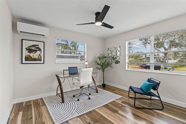 office space with wood-type flooring, an AC wall unit, and plenty of natural light