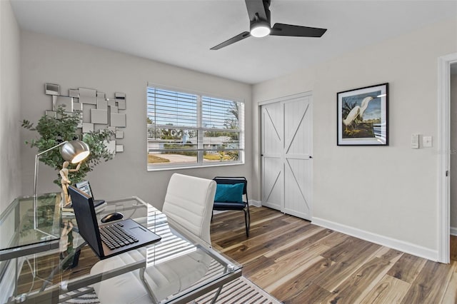 office space with hardwood / wood-style floors and ceiling fan