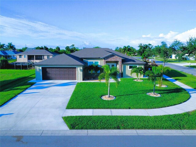 view of front of house featuring a front yard and a garage