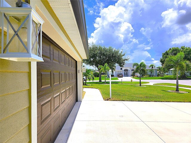 surrounding community with a garage and a yard