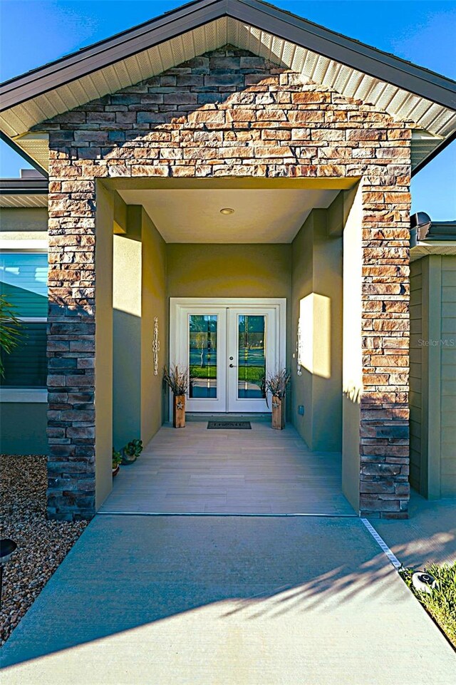 view of exterior entry featuring french doors