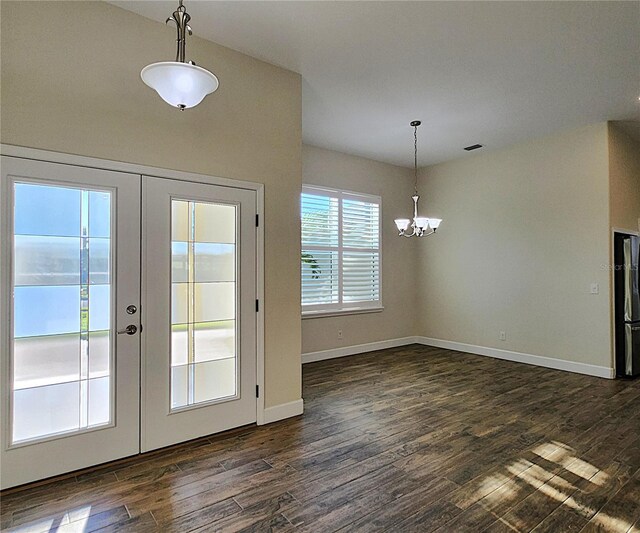 doorway featuring a notable chandelier, dark hardwood / wood-style flooring, and french doors