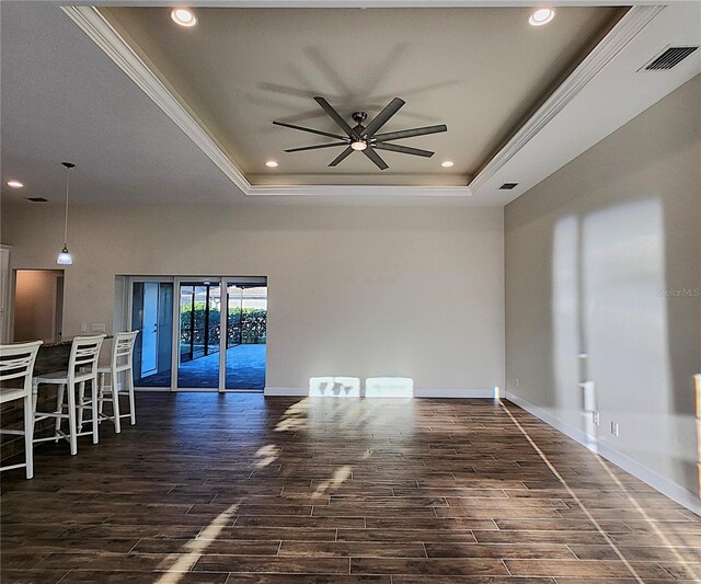 unfurnished room featuring ceiling fan, ornamental molding, and a tray ceiling