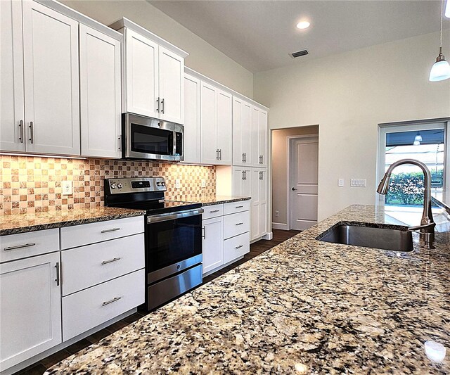 kitchen featuring white cabinetry, sink, stainless steel appliances, and stone countertops