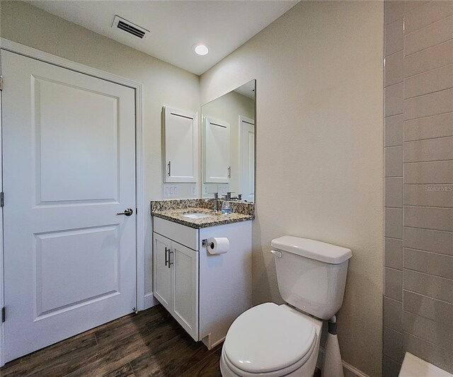 bathroom featuring hardwood / wood-style floors, vanity, and toilet