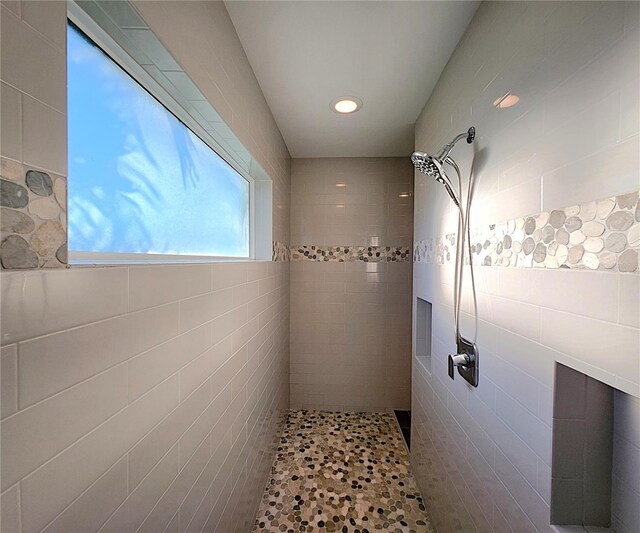 bathroom with a tile shower