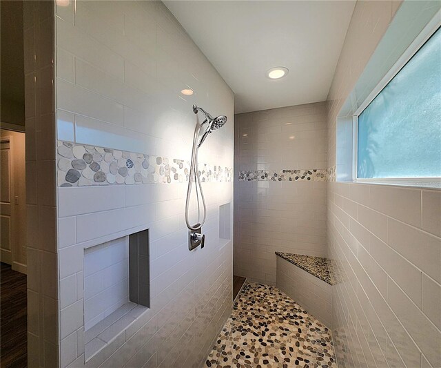 bathroom with tiled shower