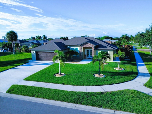 8610 Quinn Ct, North Port, FL 34287 - view of front of property with an attached garage, a front lawn, french doors, and concrete driveway