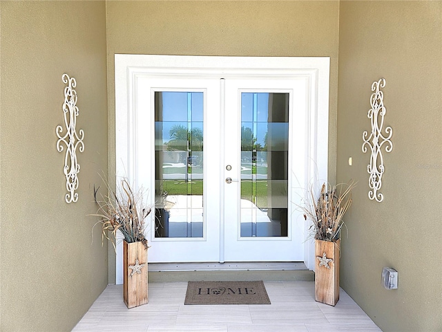 8610 Quinn Ct, North Port, FL 34287 - doorway to property with french doors and stucco siding