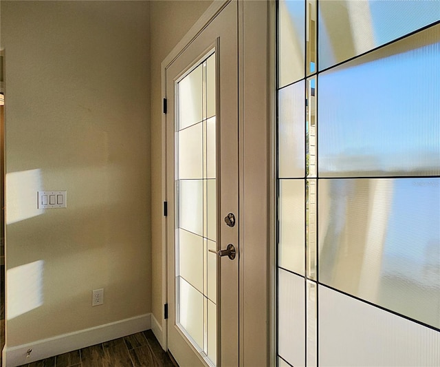 8610 Quinn Ct, North Port, FL 34287 - doorway featuring baseboards and dark wood finished floors