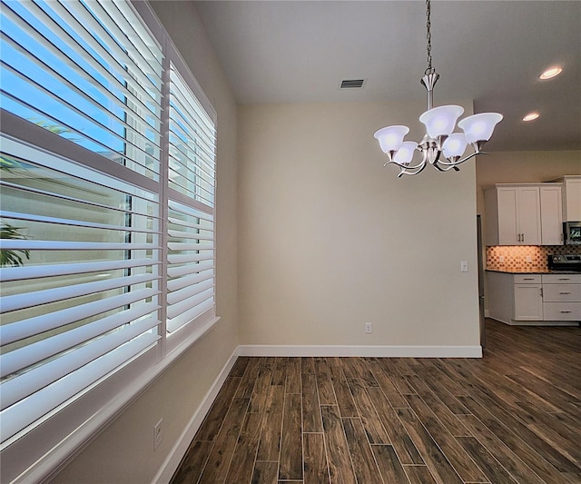 8610 Quinn Ct, North Port, FL 34287 - unfurnished dining area with baseboards, a chandelier, and a healthy amount of sunlight