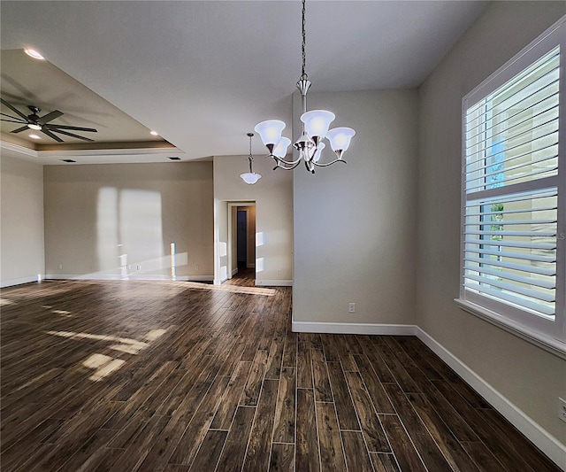 8610 Quinn Ct, North Port, FL 34287 - empty room featuring a tray ceiling, baseboards, ceiling fan with notable chandelier, and dark wood-type flooring