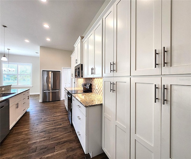 8610 Quinn Ct, North Port, FL 34287 - kitchen featuring appliances with stainless steel finishes, light stone countertops, white cabinets, dark wood-style floors, and recessed lighting