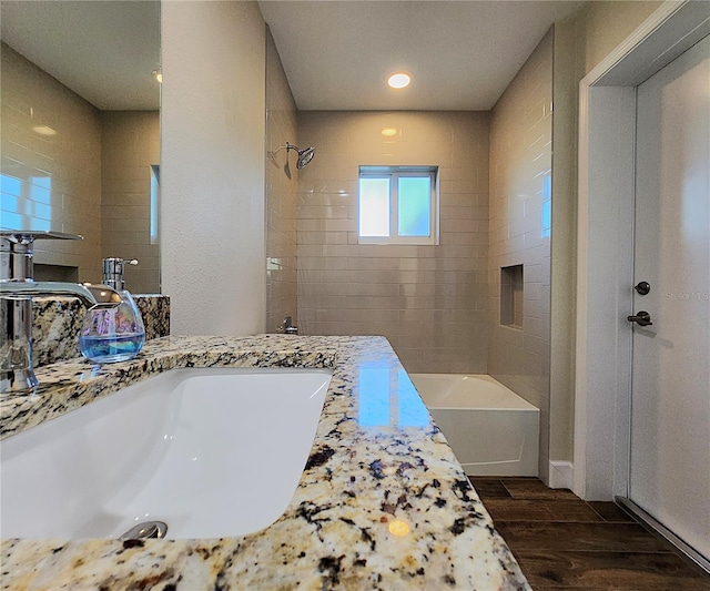 8610 Quinn Ct, North Port, FL 34287 - bathroom featuring vanity, washtub / shower combination, and wood finished floors