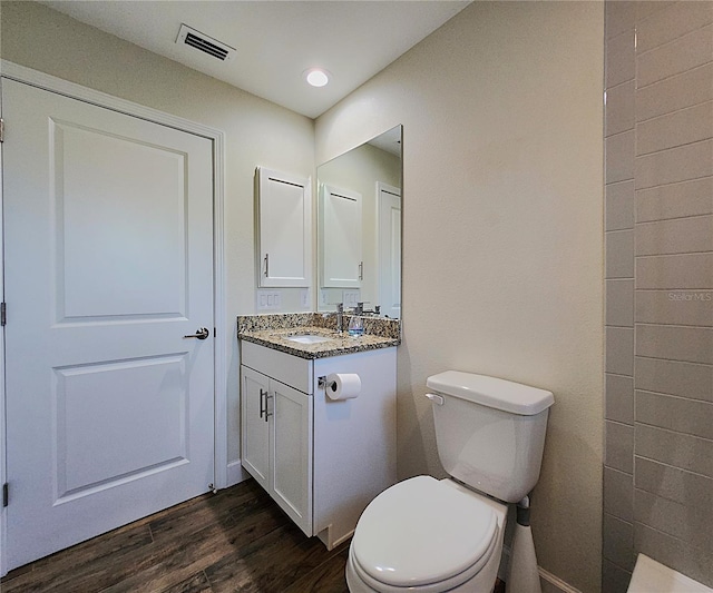 8610 Quinn Ct, North Port, FL 34287 - bathroom with vanity, toilet, wood finished floors, and visible vents