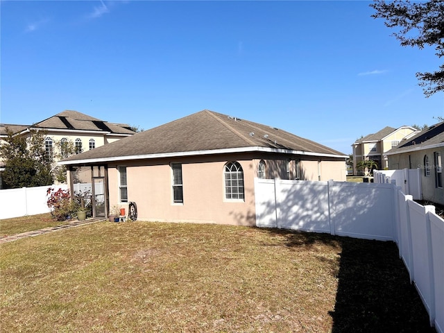 view of side of property featuring a yard