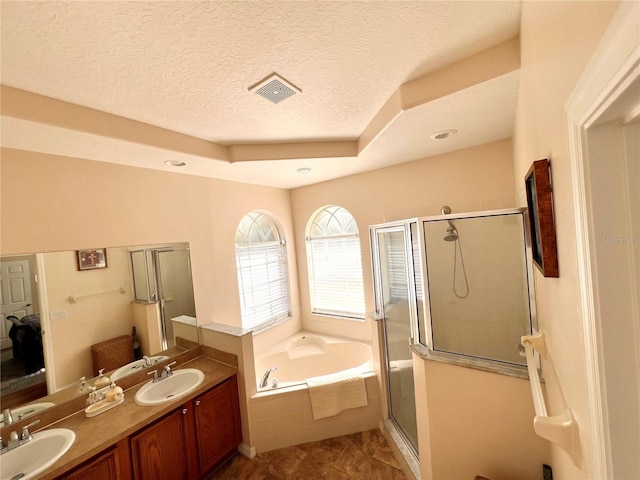 bathroom with tile patterned flooring, vanity, a textured ceiling, and independent shower and bath