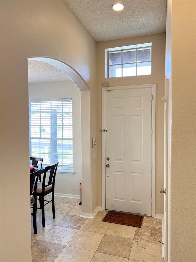 foyer entrance featuring a textured ceiling