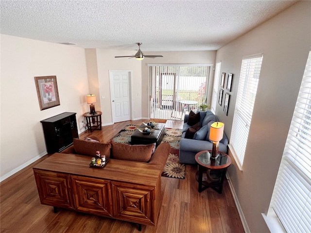 living room featuring hardwood / wood-style floors, a textured ceiling, and ceiling fan