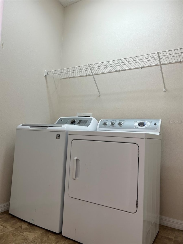 washroom with tile patterned floors and independent washer and dryer