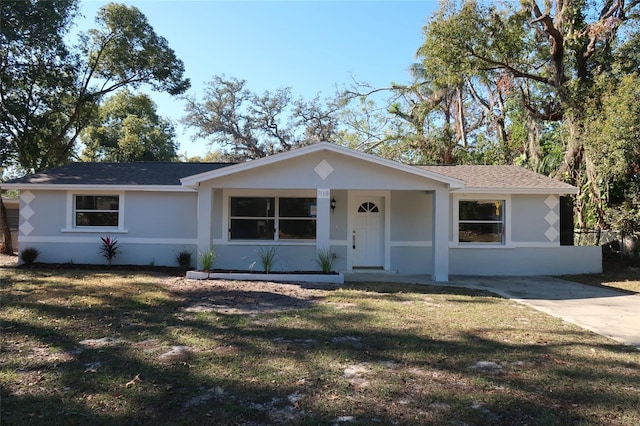 single story home with covered porch and a front yard