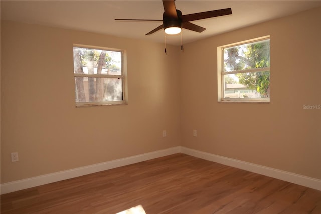 unfurnished room with ceiling fan and wood-type flooring