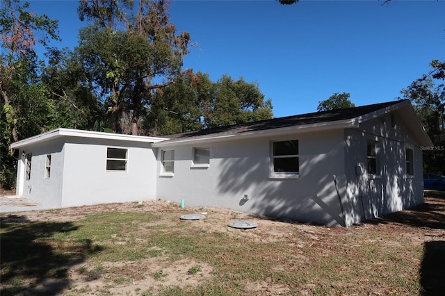 rear view of property featuring a lawn