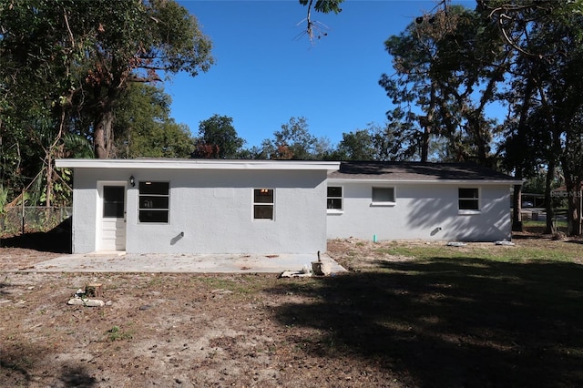 back of house with a lawn