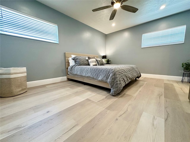 bedroom with ceiling fan and light hardwood / wood-style floors