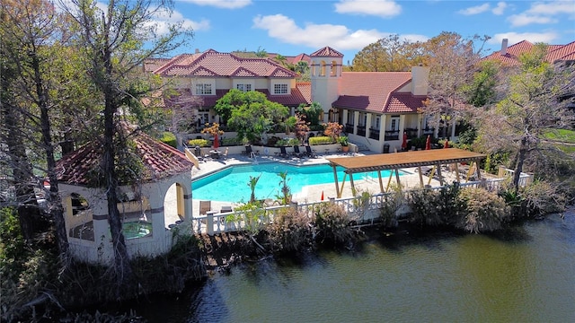 view of pool featuring a patio area and a water view