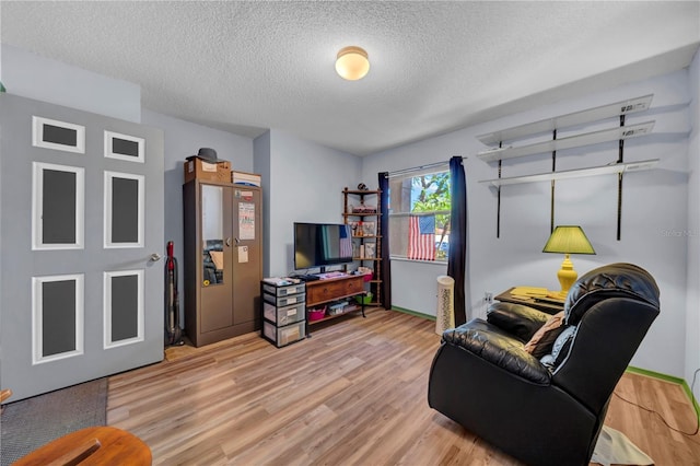 living room with hardwood / wood-style floors and a textured ceiling