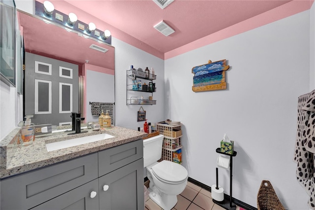 bathroom with tile patterned floors, vanity, and toilet