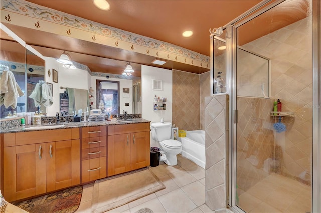 full bathroom featuring tile patterned flooring, vanity, separate shower and tub, and toilet