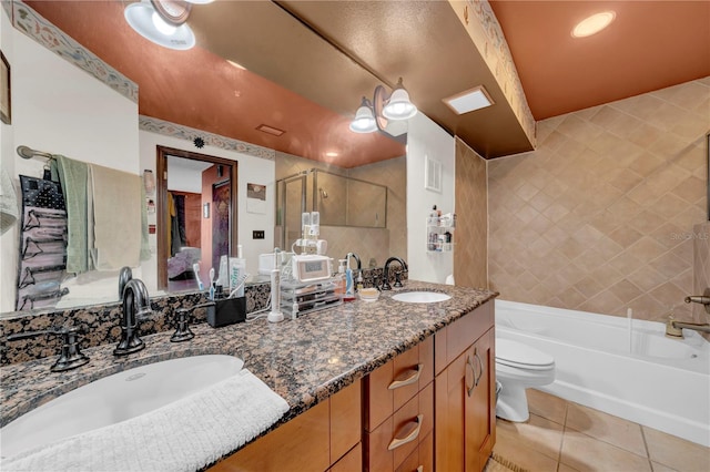 full bathroom featuring tile patterned flooring, vanity, shower with separate bathtub, and toilet