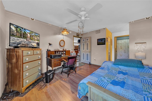 bedroom with hardwood / wood-style flooring and ceiling fan