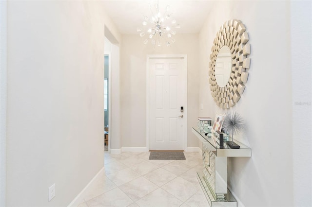 tiled entryway featuring a chandelier