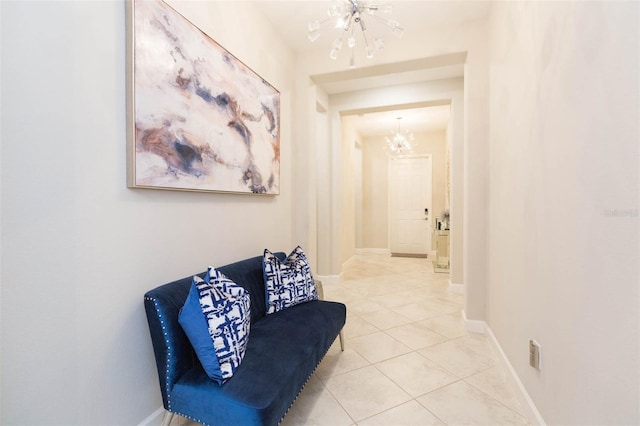 sitting room featuring tile patterned floors and a chandelier