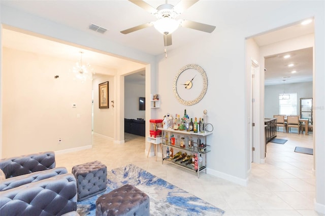 living room featuring ceiling fan with notable chandelier and light tile patterned floors