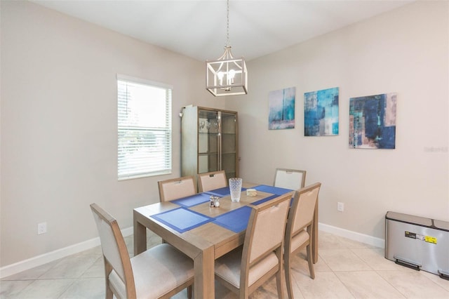 dining area with light tile patterned flooring and a chandelier