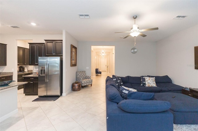 living room featuring light tile patterned flooring and ceiling fan