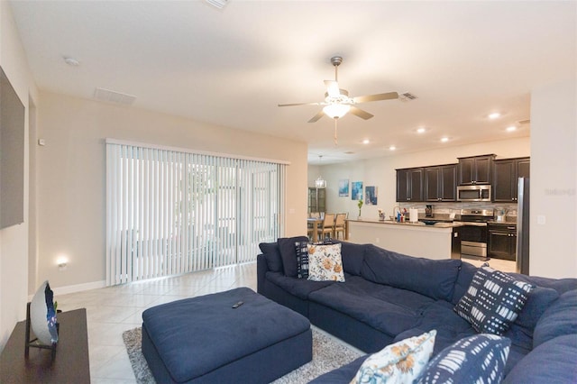 tiled living room with ceiling fan